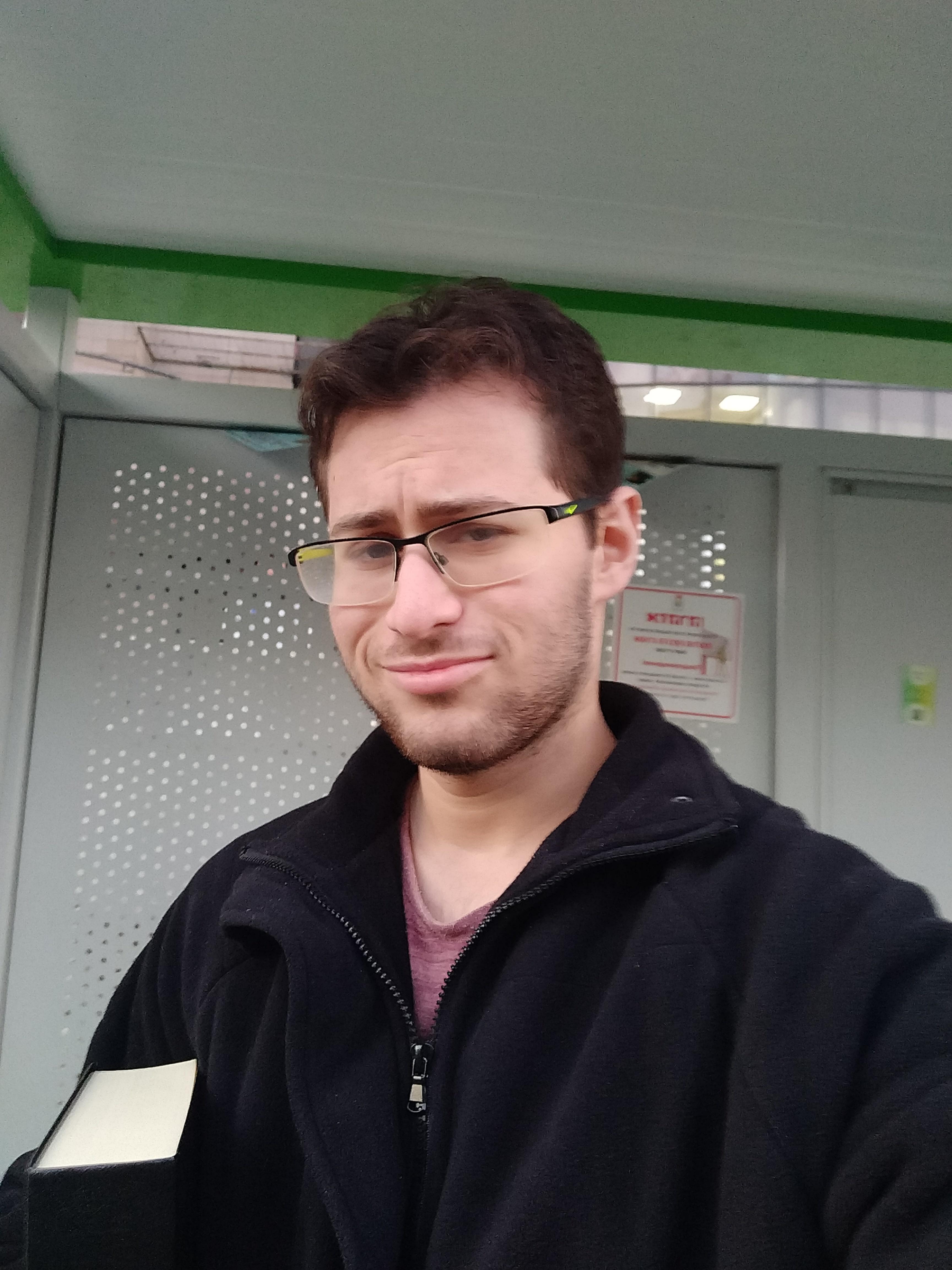 A selfie of Yuval in a bus stop